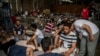 Para penyintas kapal migran yang karam duduk di gudang di pelabuhan kota Kalamata, Yunani Kamis, 15 Juni 2023 (foto: dok). Ratusan warga Pakistan jadi korban dalam insiden ini.