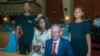 Former President for the Association of People with Albinism in Malawi, Overstone Kondowe (2nd L), poses with his wife Memory (2nd R), and their children, Promise (L), and Ellen (R), in Malawi's parliament on November 4, 2021.