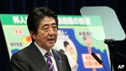 Japanese Prime Minister Shinzo Abe speaks to reporters July 1, 2014 about possible changes to the country's constitution..