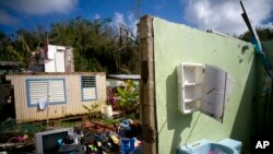 In this Saturday, Oct. 14, 2017 photo, what was once the home Arden Dragoni and his family lays in ruins after the passing of Hurricane Maria in Toa Baja, Puerto Rico. (AP Photo/Ramon Espinosa)