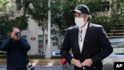 FILE - Michael Cohen arrives at his apartment in New York City, May 21, 2020. President Donald Trump's former personal lawyer was released from federal prison in May due to the coronavirus pandemic, only to be imprisoned again a short time later.