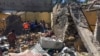 Residents sift through rubble from a destroyed building at the scene of an airstrike in Mekelle, in the Tigray region of northern Ethiopia, Oct. 28, 2021.