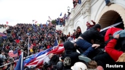 Pro-Trump protesters storm into the U.S. Capitol during a rally to contest the certification of the 2020 U.S. presidential election results by the U.S. Congress, in Washington, January 6, 2021.