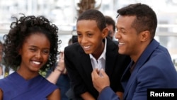 Director Yared Zeleke (R), cast members Kidist Siyum (L) and Rediat Amare pose during a photocall for the film "Lamb" in competition for the category "Un Certain Regard" at the 68th Cannes Film Festival in Cannes, southern France, May 20, 2015.