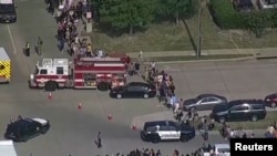 Police respond to a shooting in the Dallas area's Allen Premium Outlets