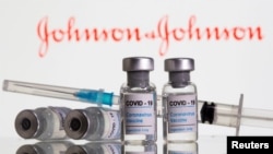 FILE PHOTO: Vials labeled "COVID-19 Coronavirus Vaccine" and syringe are seen in front of displayed Johnson&Johnson logo in this illustration taken, February 9, 2021. REUTERS/Dado Ruvic/Illustration/File Photo