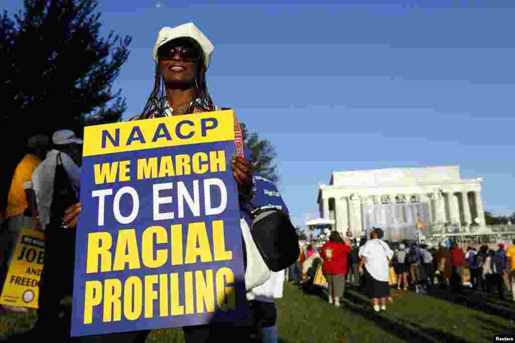 A marcher holds a sign as she attends the 50th anniversary of the 1963 March on Washington for Jobs and Freedom at the Lincoln Memorial in Washington, Aug. 24, 2013.