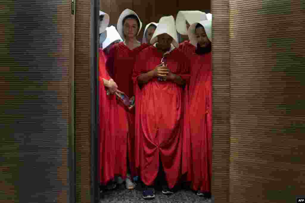 Women dressed as characters from the novel-turned-TV series "The Handmaid's Tale" stand in an elevator at the Hart Senate Office Building as Supreme Court nominee Brett Kavanaugh starts the first day of his confirmation hearing at the U.S. Senate on Capitol Hill in Washington.