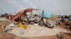 Horoun Dadoum, 80, a Sudanese man who fled the conflict in Murn in Sudan's Darfur region, sits with his wife Fatma Abdelkareem, 70, by his belongings as they arrived only yesterday in Adre, Chad, July 24, 2023.