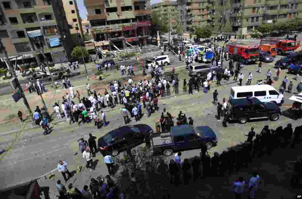 People gather at a site of an explosion near the convoy of the Egyptian Interior Minister Mohamed Ibrahim, Cairo, Sept. 5, 2013.