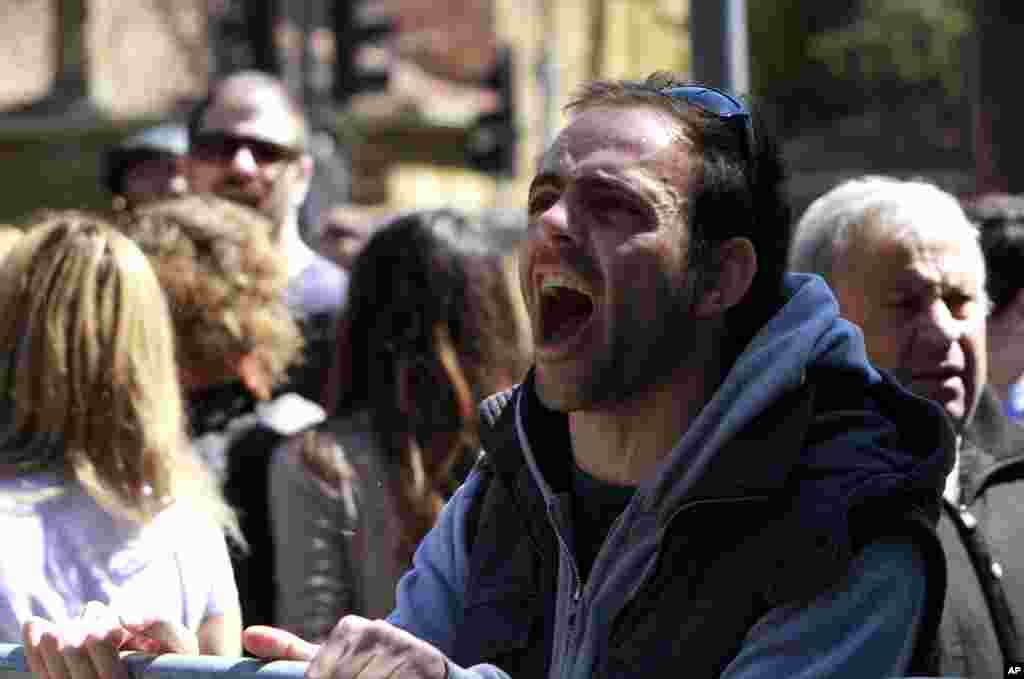 A protester shouts slogans outside of parliament during a meeting in Nicosia, Cyprus, March 18, 2013.