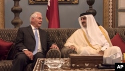 FILE - US Secretary of State Rex Tillerson meets with the Emir of Qatar, Sheikh Tamim Bin Hamad Al Thani at the Sea Palace, in Doha, Qatar, July 11, 2017. 