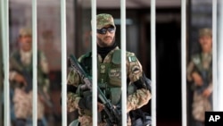 In Islamabad, Pakistani army soldiers stand guard during an emergency session of parliament, with thousands of protesters demanding the prime minister's resignation Sept. 2, 2014.