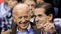 FILE PHOTO: U.S. Vice President Joe Biden and his son Hunter Biden attend an NCAA basketball game between Georgetown University and Duke University in Washington, U.S., January 30, 2010. REUTERS/Jonathan Ernst -/File Photo