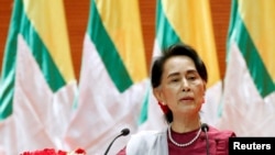 FILE - Myanmar State Counselor Aung San Suu Kyi delivers a speech to the nation over Rakhine and Rohingya situation, in Naypyitaw, Myanmar Sep. 19, 2017. 
