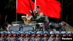 FILE - Troops prepare for the arrival of Chinese President Xi Jinping, June 30, 2017, at the People's Liberation Army Hong Kong Garrison in Hong Kong.