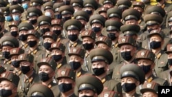 FILE - Soldiers wearing face masks to help cut coronavirus transmission rally to welcome the 8th Congress of the Workers' Party of Korea at Kim Il Sung Square in Pyongyang, North Korea, Oct 12, 2020. 
