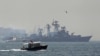 A Turkish Navy cost guard boat (L) escorts the Russian Navy destroyer Smetlivy, in the Bosphorus in Istanbul, July 11, 2012. 