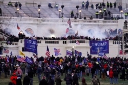 FILE - Rioters storm the Capitol, in Washington, Jan. 6, 2021.