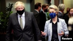 FILE - European Commission President Ursula von der Leyen welcomes British Prime Minister Boris Johnson in Brussels, Belgium, Dec. 9, 2020.
