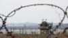 South Korean army soldiers patrol along the barbed-wire fence in Paju, South Korea, near the border with North Korea, on Jan. 5, 2022.