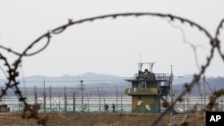 South Korean army soldiers patrol along the barbed-wire fence in Paju, South Korea, near the border with North Korea, on Jan. 5, 2022.