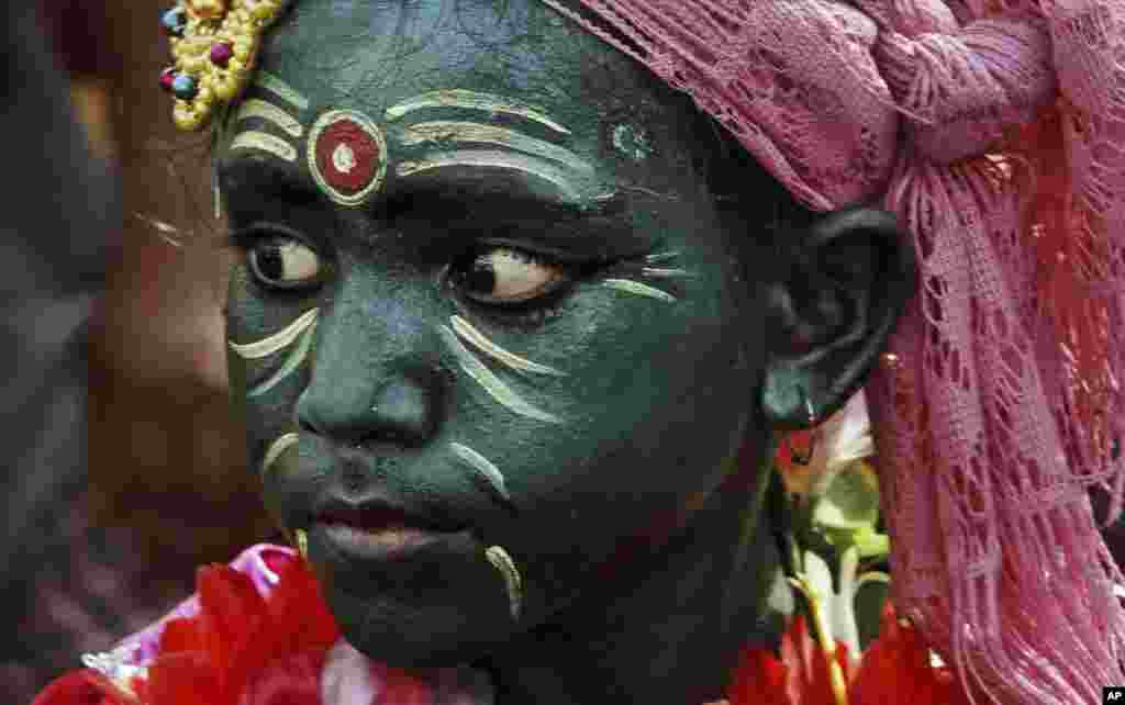 An Indian boy with his face painted participates in a procession on the occasion of Chandan Yatra festival in Puri, 65 kilometers (40 miles) from the eastern Indian city of Bhubaneswar. Chandan Yatra means Sandalwood Voyage, where devotees smear the deities of the Lord with cooling sandalwood paste.
