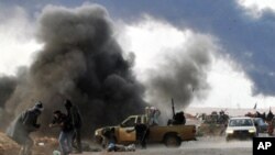 Wapiganaji waasi huko Libya wanajiepusha na makombora yanayolipuka wakati wa mapambano na majeshi yanayomtii kiongozi wa Libya, Moammar Gadhafi, kilometa chache nje ya mji wa unaozalisha mafuta wa Ras Lanuf.