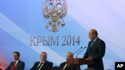 Russian President Vladimir Putin addresses Russian Duma lawmakers during a meeting in Mria sanatorium about 30 kilometers (19 miles) from Yalta, Crimea, Aug. 14, 2014. 