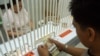 A customer counts Philippine pesos at a money changer in Manila, (File photo).