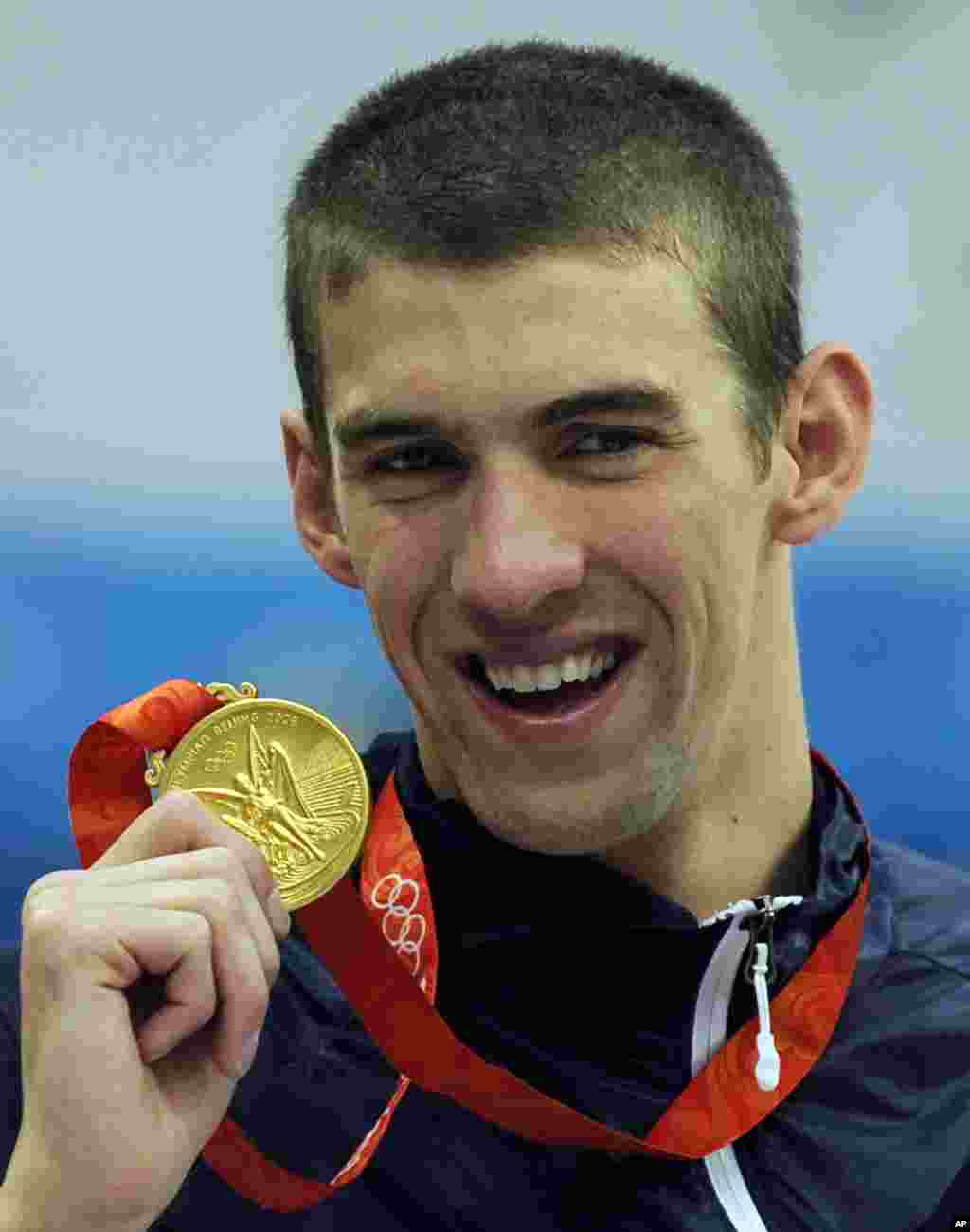 Michael Phelps displays his eighth gold medal after the men's 4x100-meter medley relay final at the Beijing 2008 Olympics in Beijing.