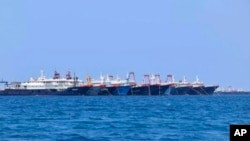  In this Sunday, March 7, 2021, photo provided Sunday, March 21, 2021, by the Philippine Coast Guard/National Task Force-West Philippine Sea, some of the 220 Chinese vessels are seen moored at Whitsun Reef, South China Sea.