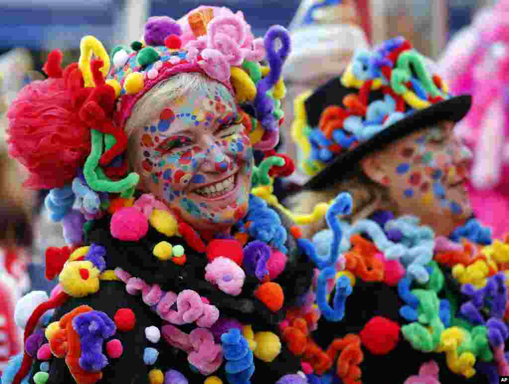 People celebrate in the streets of downtown Duesseldorf after the symbolic awakening of the Hoppeditz, the symbol for carnival, Germany.