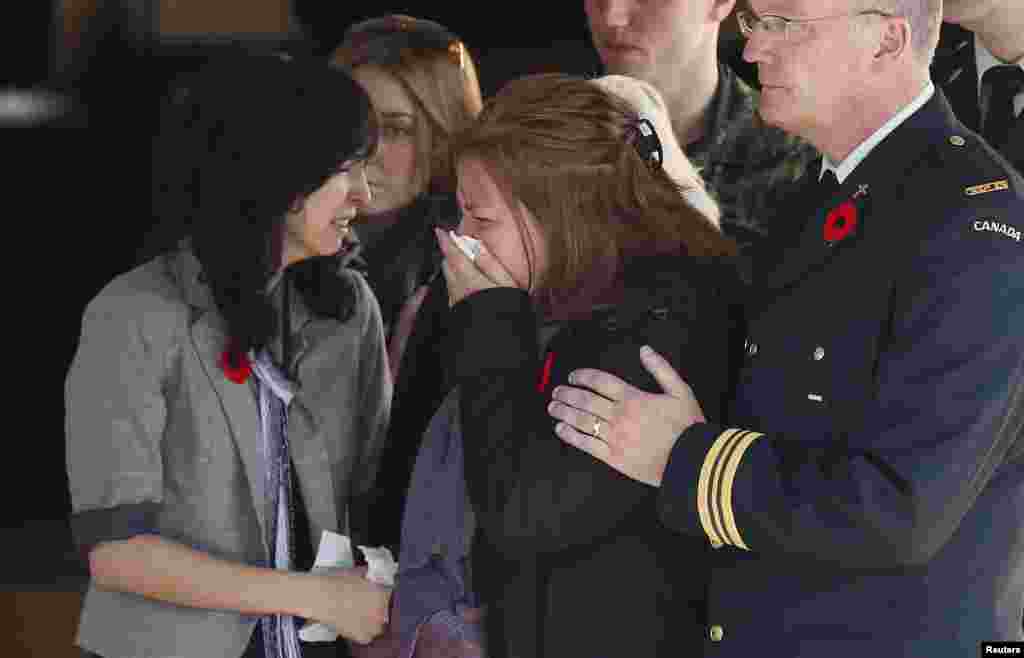 Kathy Cirillo, the mother of Cpl. Nathan Cirillo, the serviceman who was killed when a gunman attacked multiple locations in downtown Ottawa, reacts as his casket is placed in a hearse at a funeral home in Ottawa, Oct. 24, 2014.
