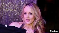 Adult-film actress Stephanie Clifford, also known as Stormy Daniels, poses for pictures at the end of her show at the Gossip Club in Long Island, New York, Feb. 23, 2018. 