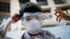 A Hong Kong pro-democracy protester covers his face in plastic wrap to protect against pepper spray in the event that it is used by the police, Sept. 29, 2014.