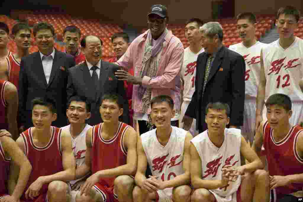Dennis Rodman poses for pictures with North Korean basketball players and government officials during a practice session in Pyongyang, Dec. 20, 2013.