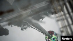 New Year's Eve ball at the roof of One Times Square building is reflected in a puddle during the New Year's Eve Ball test, before the official New Year Celebration at Times Square, Manhattan, New York, Dec. 30, 2019. 