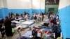 FILE - Migrants are seen at a detention center in Zawiya, west of Tripoli, Libya, April 26,2019.