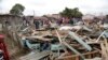 People and rescuers walk on debris of The Precious Talent Top School in Nairobi, Kenya, Sept. 23, 2019. 