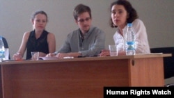Edward Snowden at the Moscow airport July 12, 2013, with Sarah Harrison of Wikileaks on the left side of the photo.