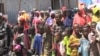 Twice a day, crowds of hungry people line up outside feeding centers all across Mogadishu, holding a pan or a bucket to receive a hot meal