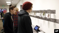 Customers look at product displays at Shango Premium Cannabis, in Portland , Oregon, Oct. 1, 2015. 