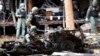 FILE - Thai bomb squad officers examine the wreckage of a car after an explosion outside a hotel in Pattani province, southern Thailand, Aug. 24, 2016.