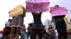 Women wearing miniskirts and tight leggings hold posters to protest against the idea that provocatively dressed women are to blame for sexual assaults, Jakarta, Indonesia (September 2011 File)