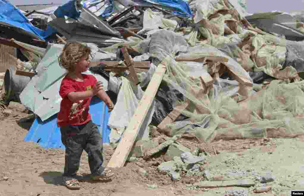 A Palestinian girl cries as she walks past her family's house after it was demolished by Israeli bulldozers in Om Ajaj village, north of the West Bank city of Jericho.