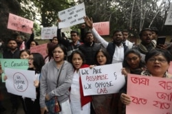 People from northeastern Indian states shout slogans against the government during a protest against Citizenship Amendment Bill (CAB), in New Delhi, India, Dec. 11, 2019.