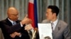 Philippine Congressman Rodolfo Biazon, left, Chair of the House Committee on National Defense, and Hiroshi Nakada, Head of delegation of the Japanese opposition Party for Future Generations, shake hands shortly after signing a non-binding documents to rea