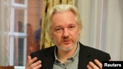 FILE - WikiLeaks founder Julian Assange gestures during a news conference at the Ecuadorian embassy in central London, August 18, 2014. 