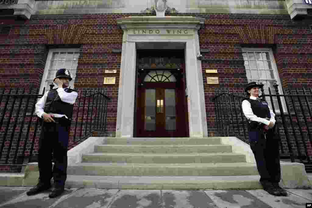 British police officers guard the entrance of St. Mary's Hospital exclusive Lindo Wing in London, July 22, 2013.